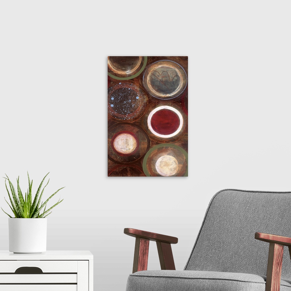 A modern room featuring Vertical modern painting of circles in multiple colors with speckles of blue paint overlapping.