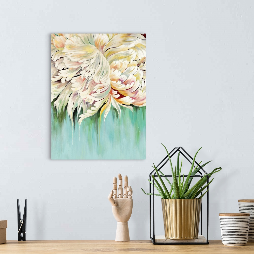 A bohemian room featuring A complementary painting of a large white blooming flower, with hints of yellow and red.