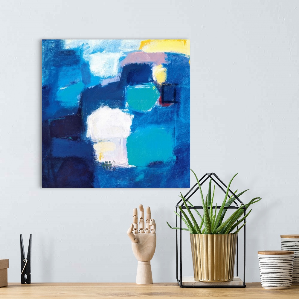 A bohemian room featuring A modern abstract painting of square style shapes in shades of blue with accent colors of yellow ...