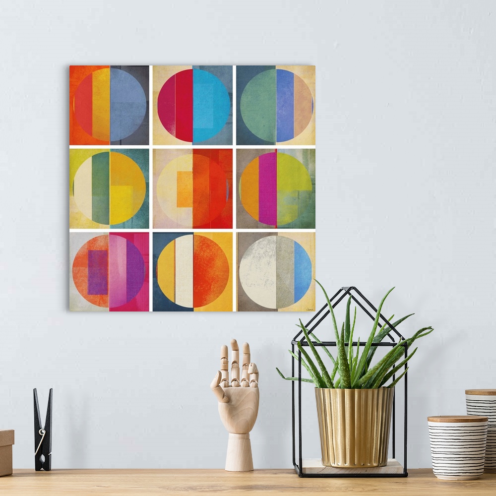 A bohemian room featuring A square abstract of rows of multi-colored circles within boxes divided by white lines.