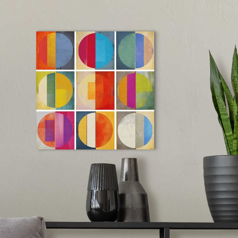 A modern room featuring A square abstract of rows of multi-colored circles within boxes divided by white lines.