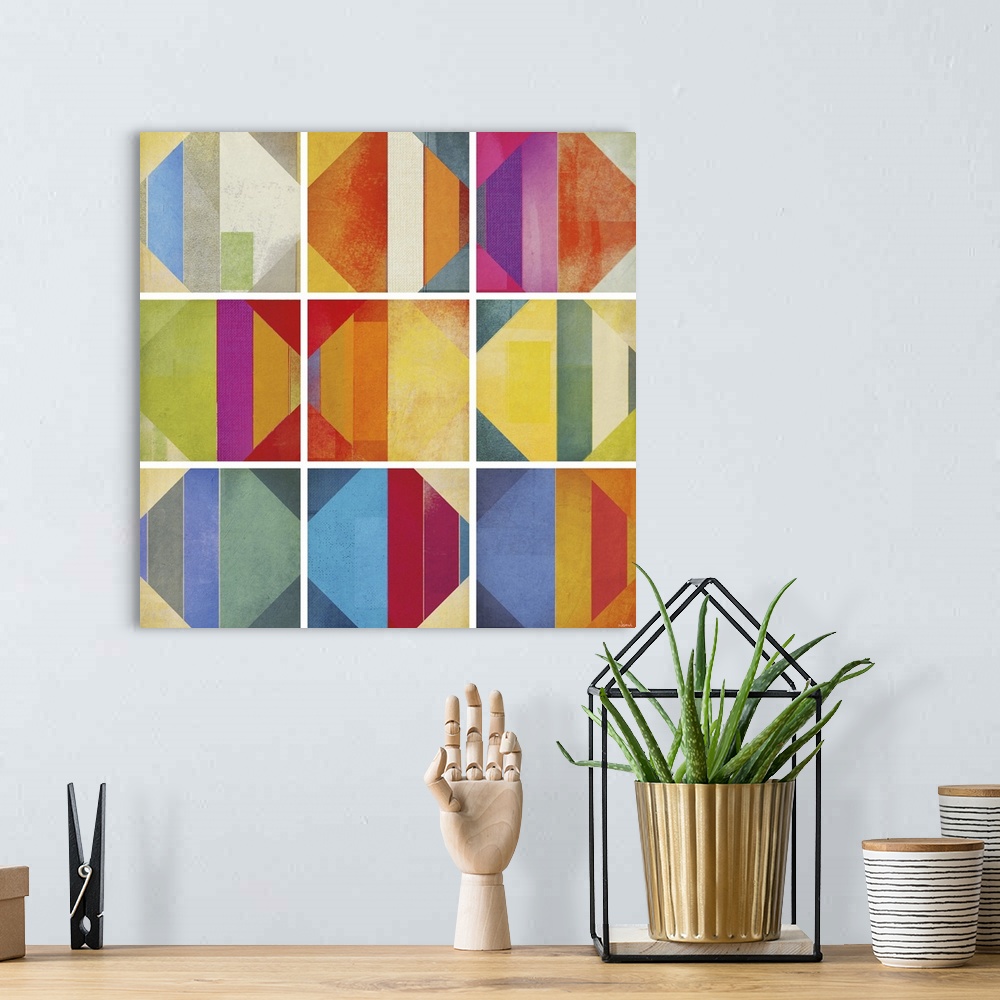 A bohemian room featuring A square abstract of rows of multi-colored diamond shapes within boxes divided by white lines.