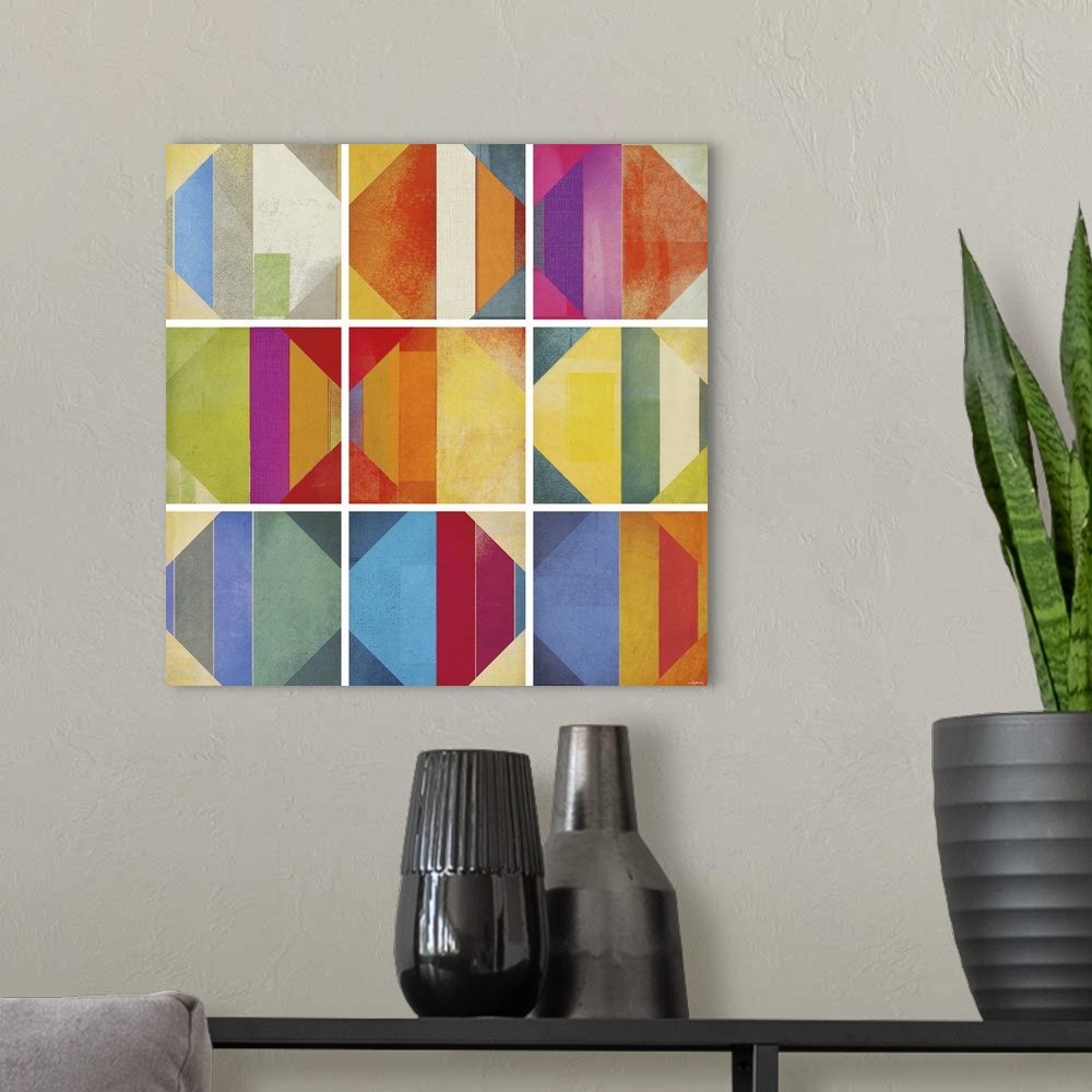 A modern room featuring A square abstract of rows of multi-colored diamond shapes within boxes divided by white lines.