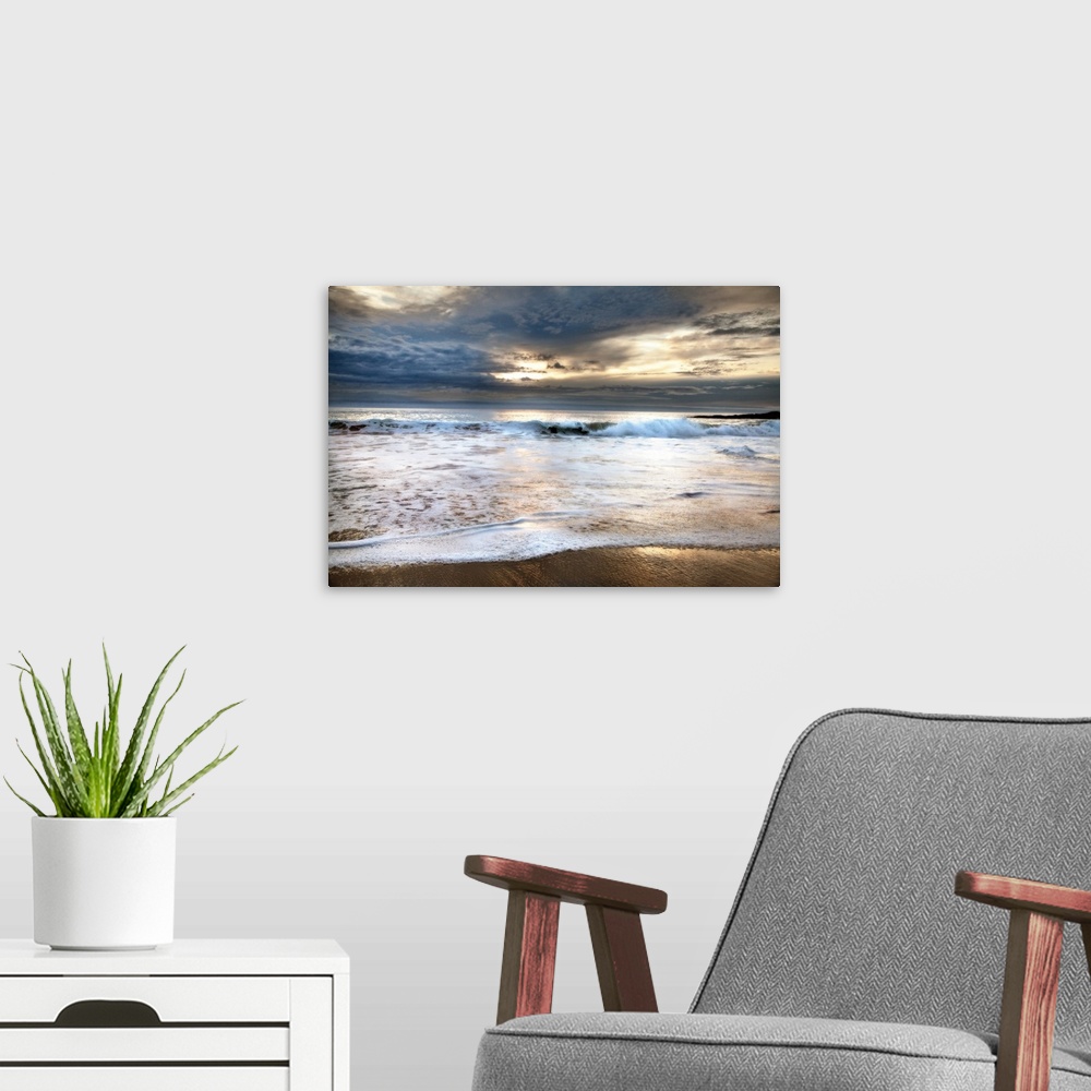 A modern room featuring Photograph of foamy waves crashing onto the beach with a stormy sky above.