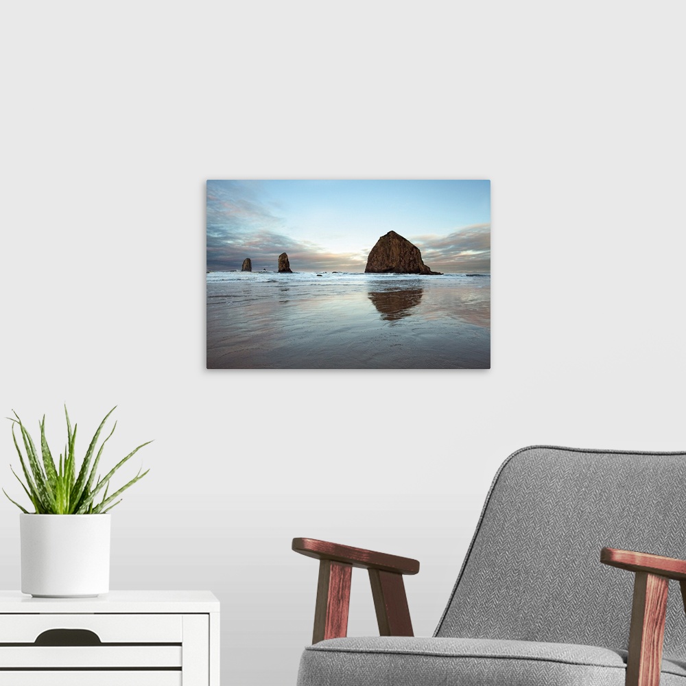 A modern room featuring Photograph of large rocks along the coastline of a beach.