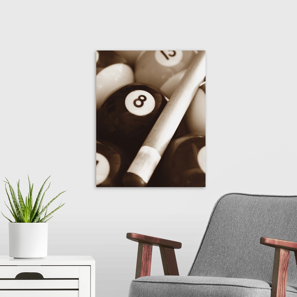 A modern room featuring Sepia toned photo of a pool cue and pool balls.
