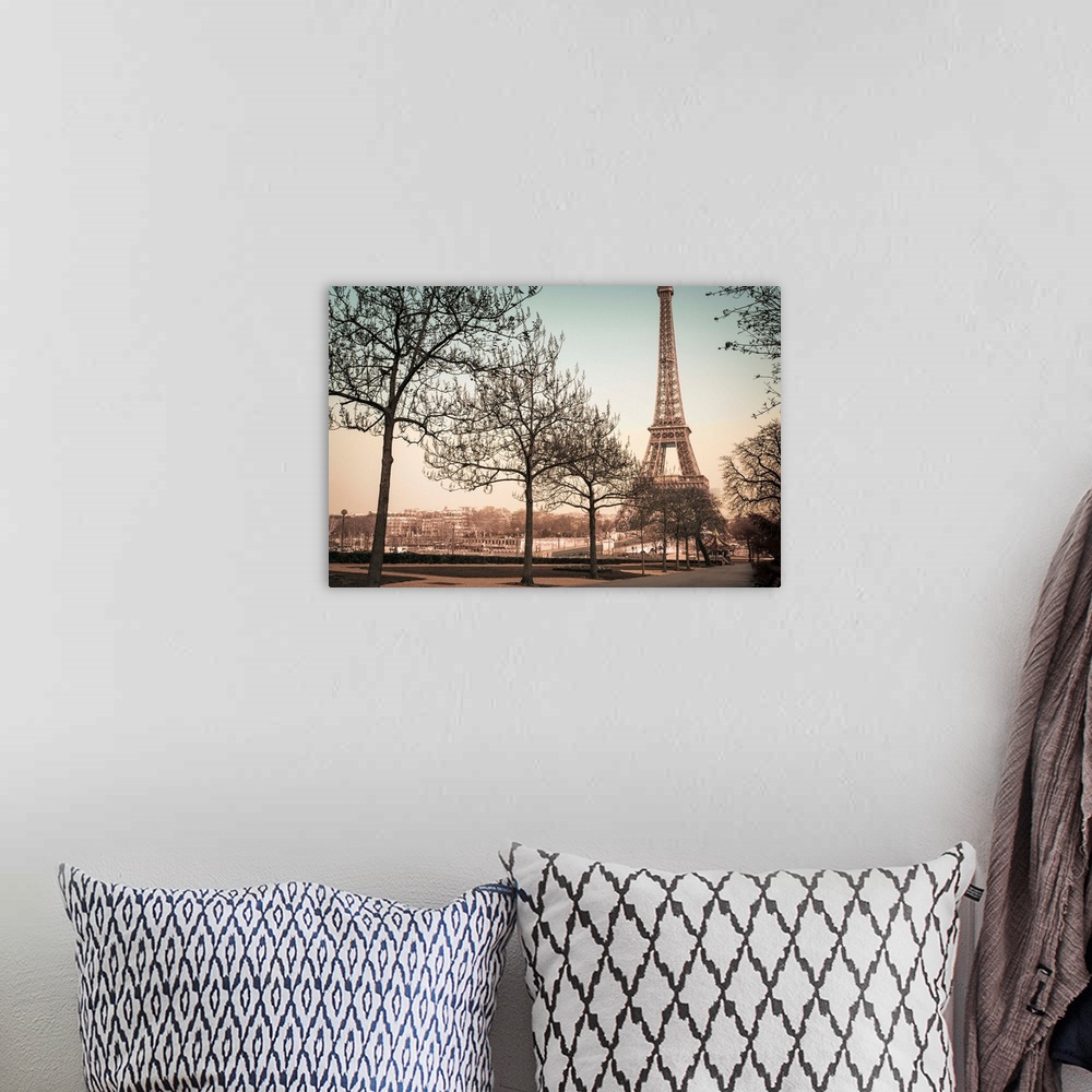 A bohemian room featuring A muted colored photograph of the Eiffel Tower, viewed from a park sidewalk, in Paris, France.