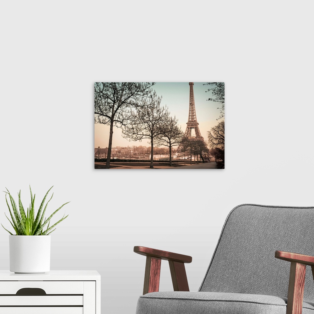 A modern room featuring A muted colored photograph of the Eiffel Tower, viewed from a park sidewalk, in Paris, France.