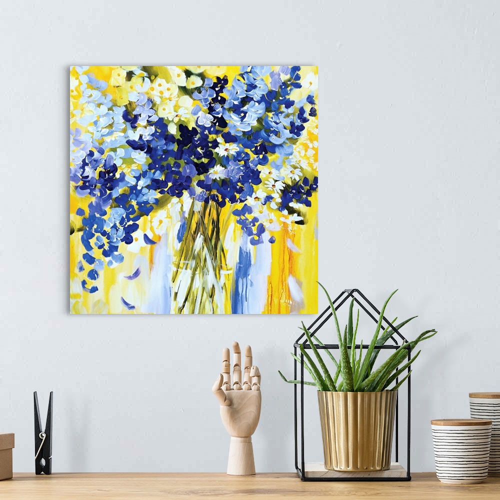 A bohemian room featuring Square painting of blue and white blooms on a bright yellow background.