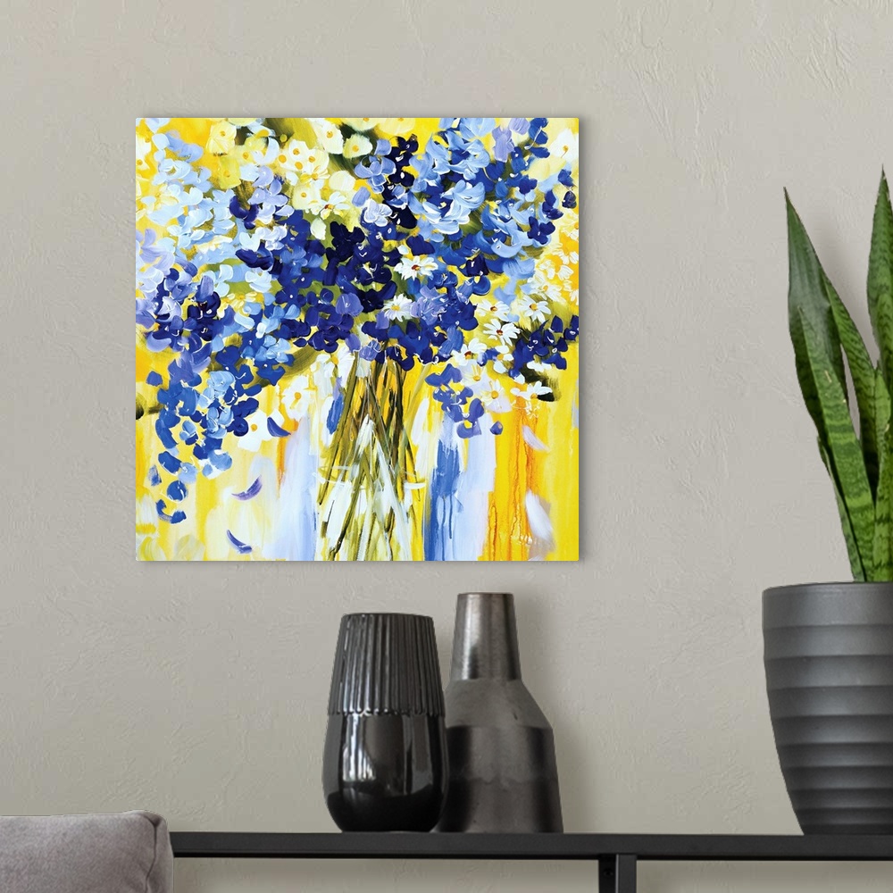 A modern room featuring Square painting of blue and white blooms on a bright yellow background.