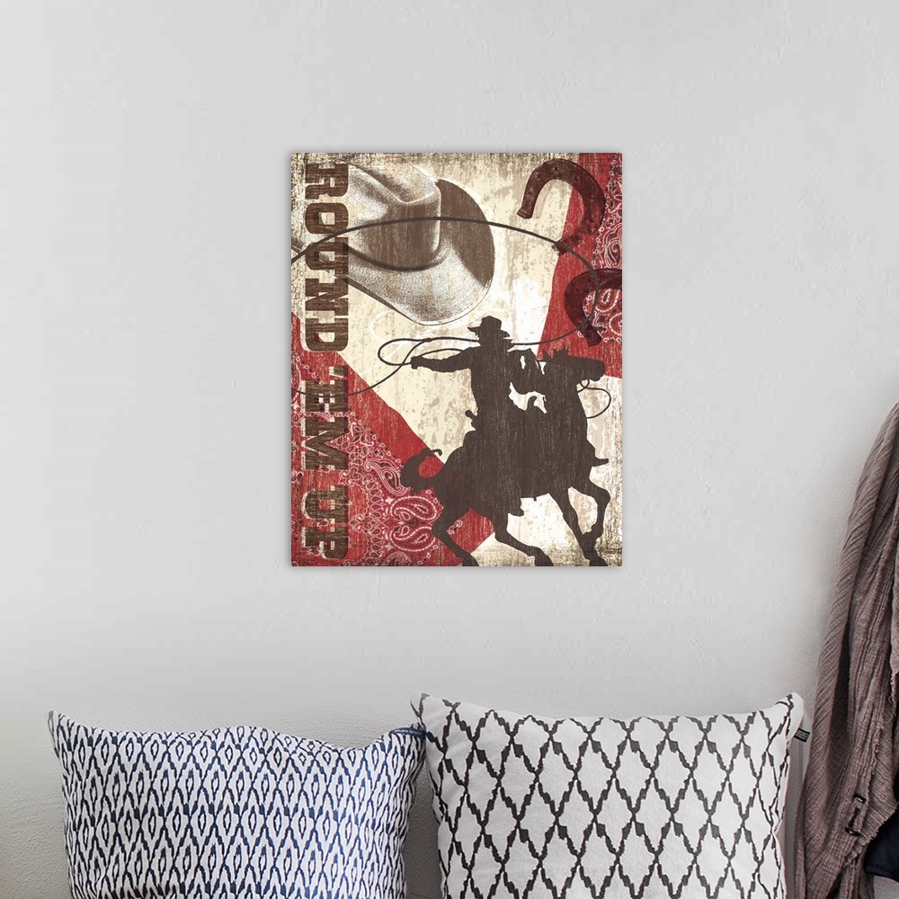 A bohemian room featuring "Round'Em Up" artwork with cowboy hat, horseshoes, bandana and a man riding a horse.