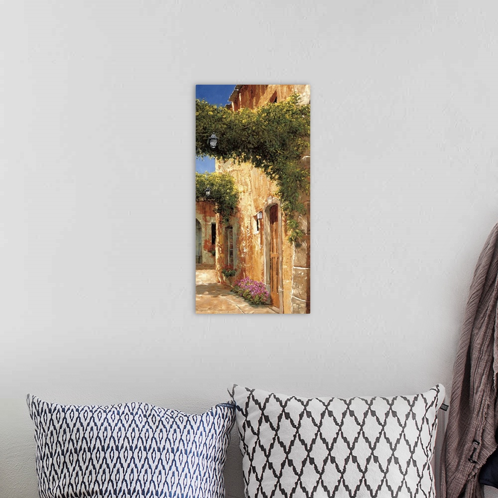 A bohemian room featuring Artwork of archways covered in vines in a European village.