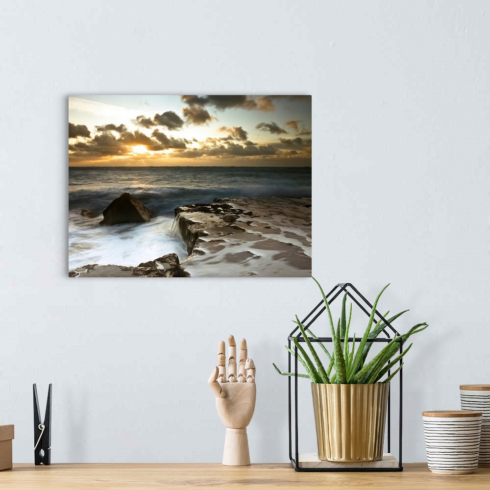 A bohemian room featuring Image of a rocky coastline during a cloudy sunset.