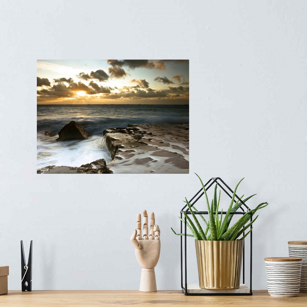 A bohemian room featuring Image of a rocky coastline during a cloudy sunset.