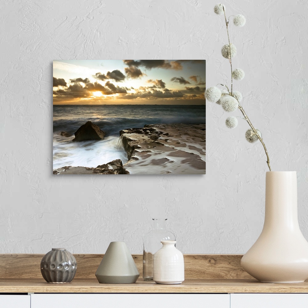 A farmhouse room featuring Image of a rocky coastline during a cloudy sunset.