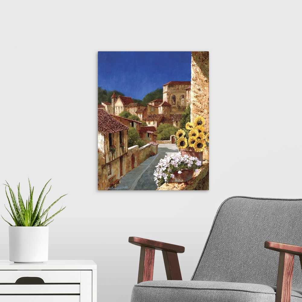 A modern room featuring A vertical complementary painting of buildings of stone and terracotta in a village in Europe.