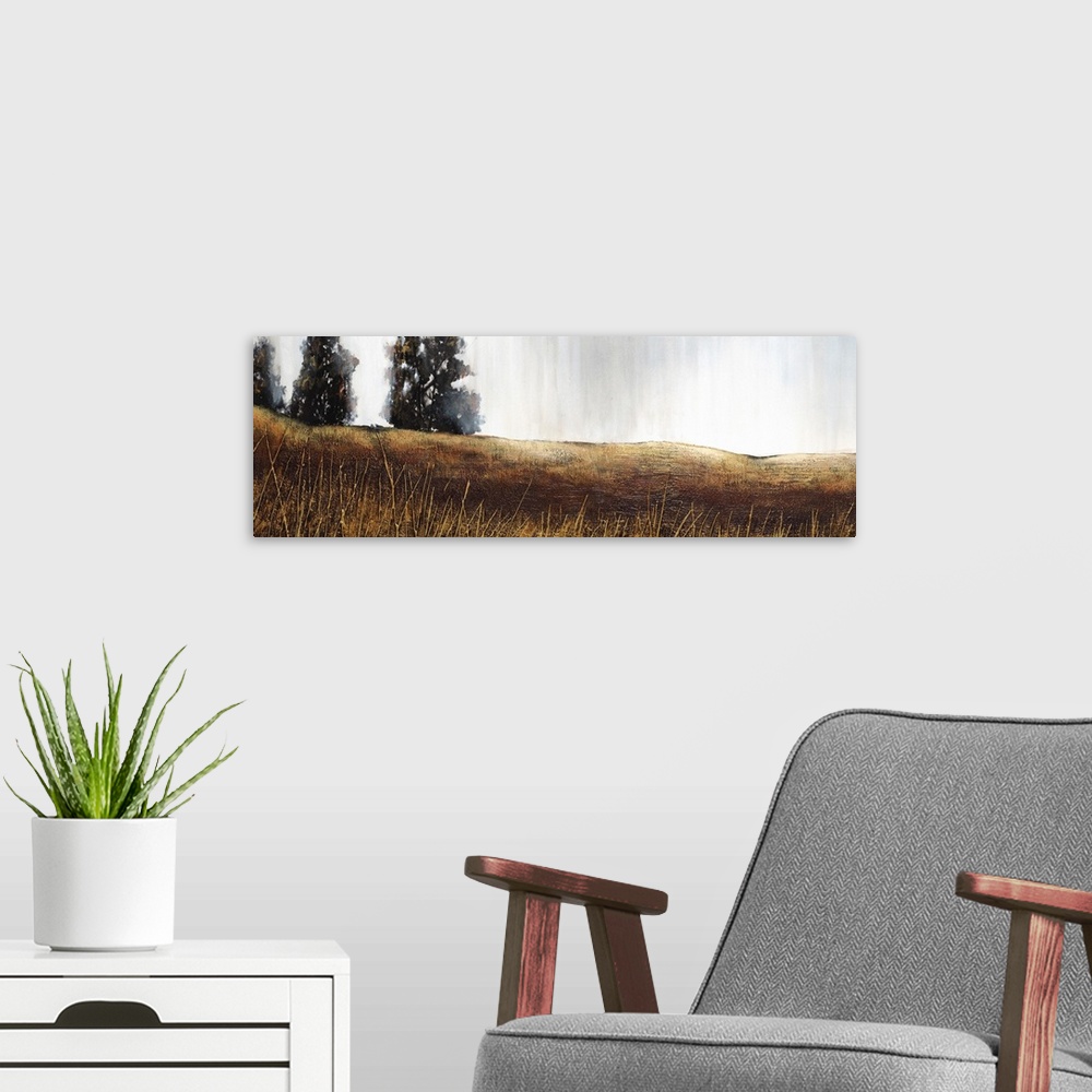 A modern room featuring Contemporary panoramic painting of a field of grass in shades of brown with a few trees along the...
