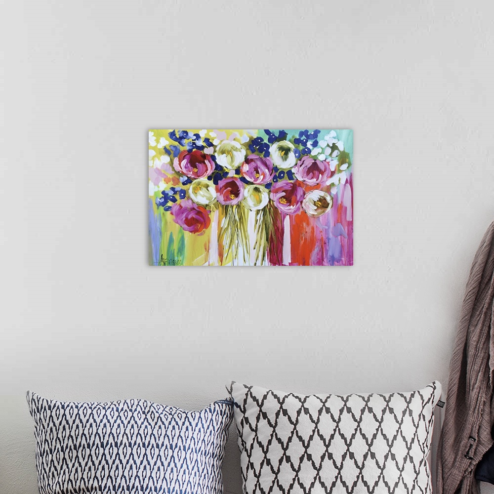 A bohemian room featuring A colorful contemporary painting of a group of flowers on a multi-colored background.
