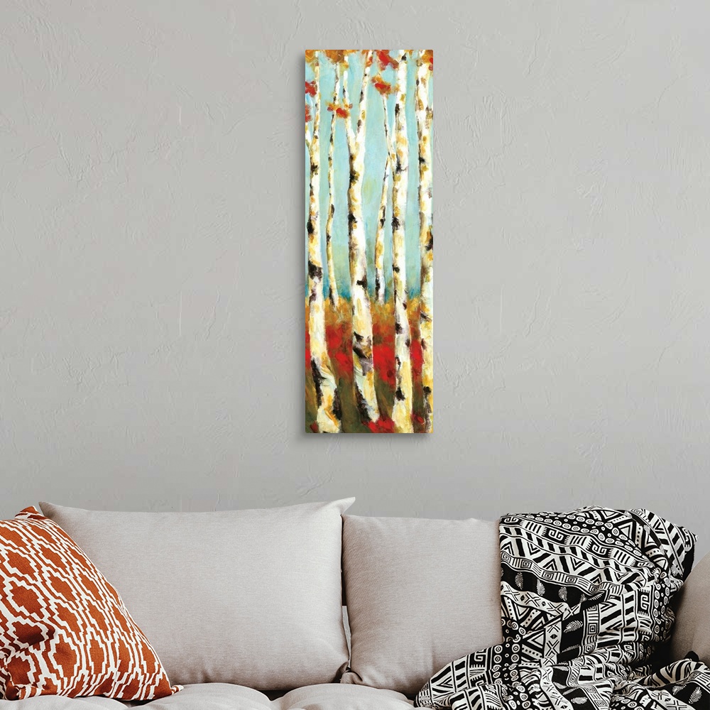 A bohemian room featuring A long vertical painting of white birch trees with warm colored grass and leaves.