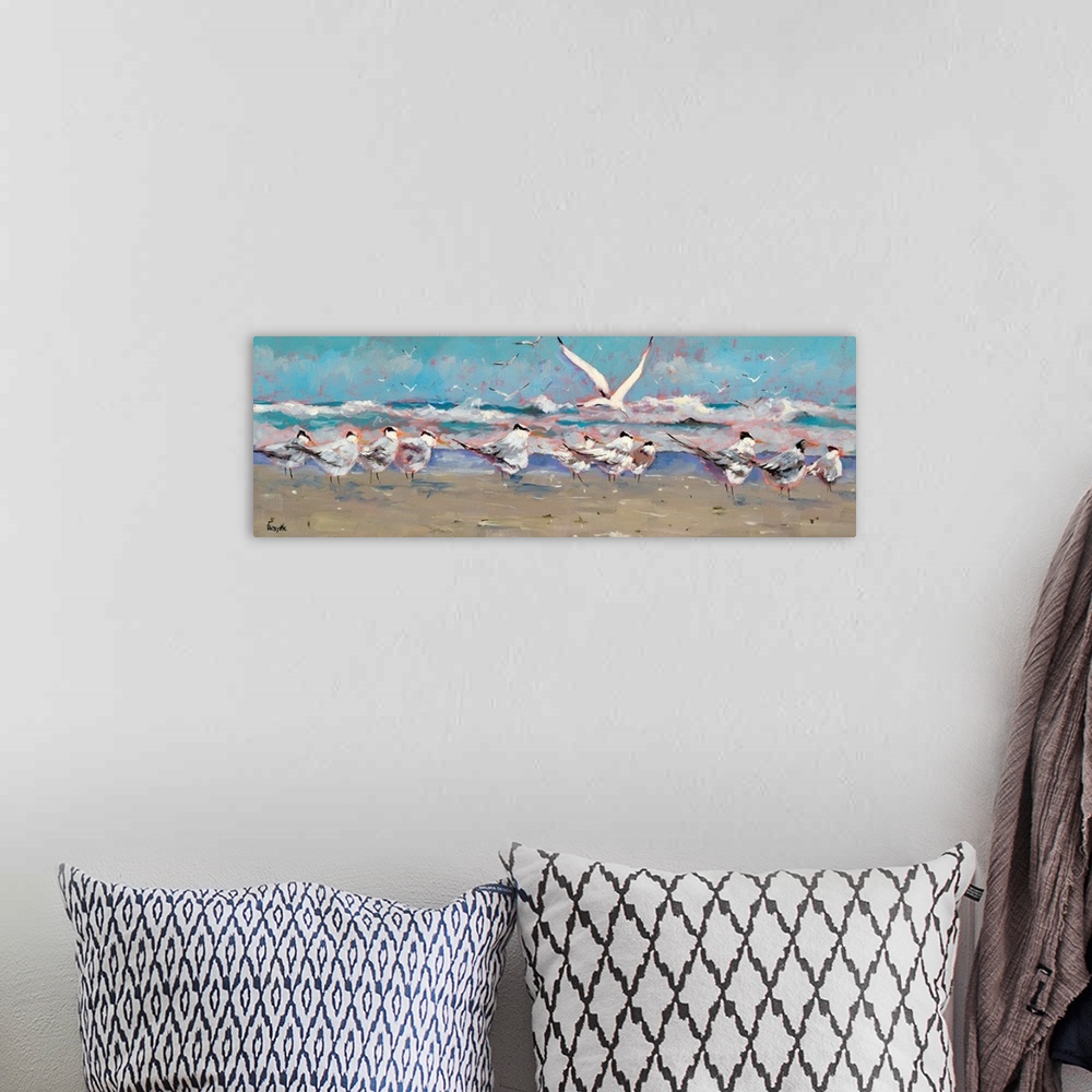 A bohemian room featuring A panoramic landscape of a beach scene with a group of seagulls along the shoreline while the oce...