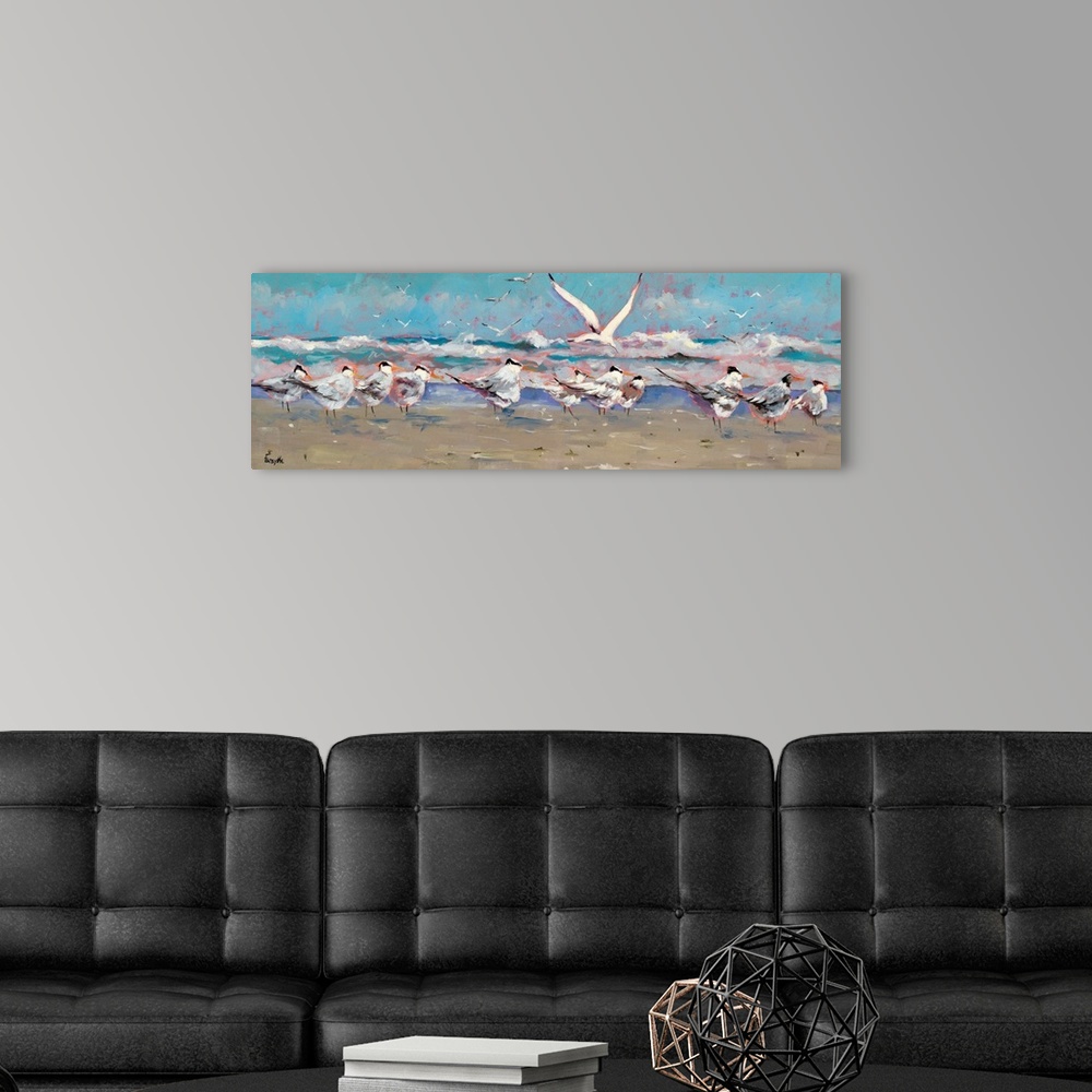 A modern room featuring A panoramic landscape of a beach scene with a group of seagulls along the shoreline while the oce...