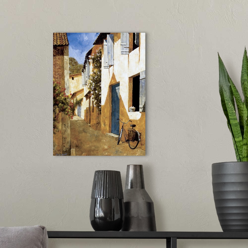 A modern room featuring Painting of a bicycle near a door in a European village.