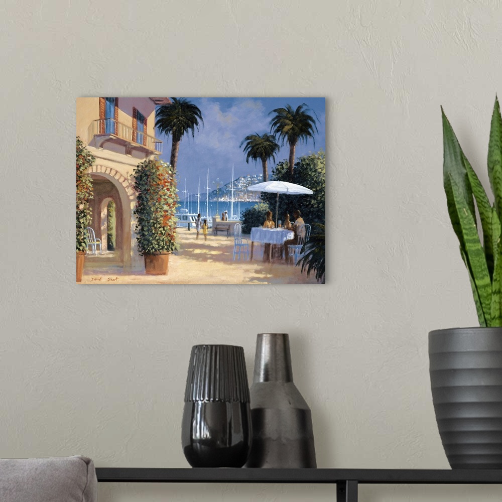 A modern room featuring Contemporary artwork of an outdoor bistro in the sun in a seaside town.
