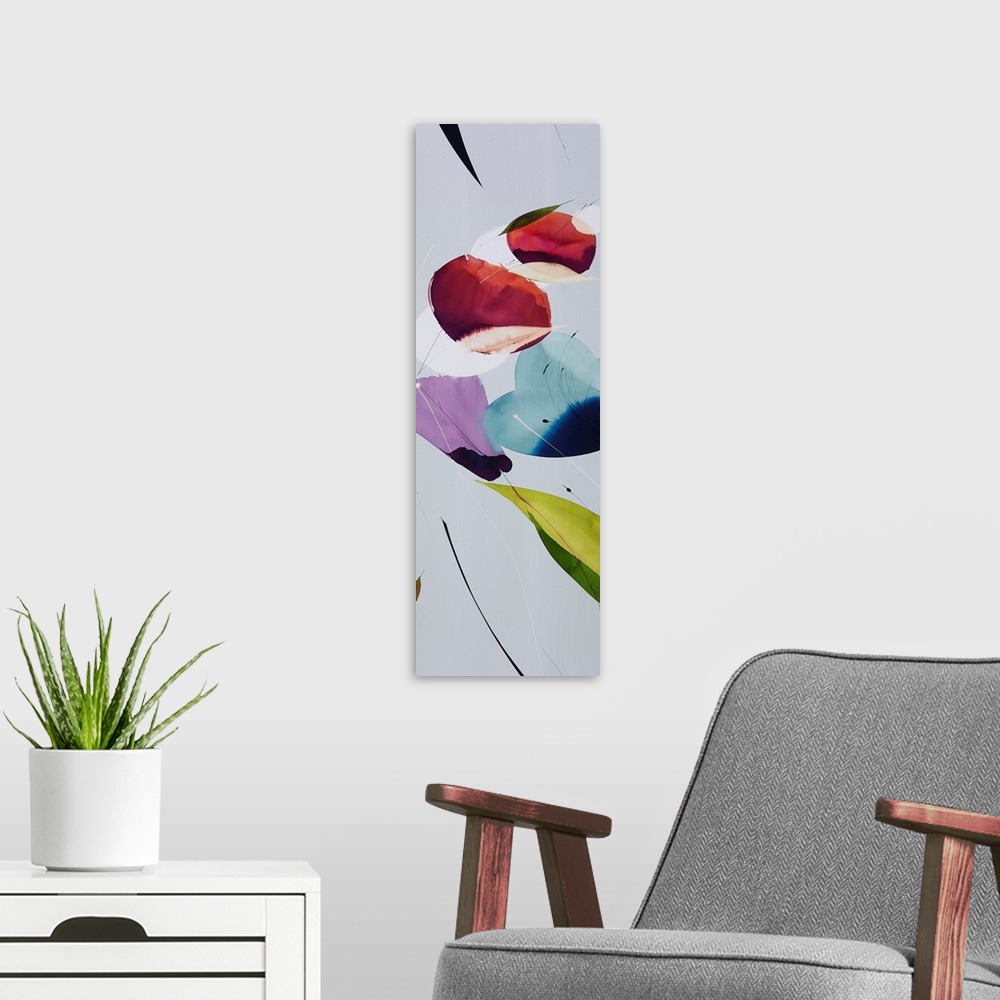 A modern room featuring A long vertical painting in a modern design of flowers in cool tones.