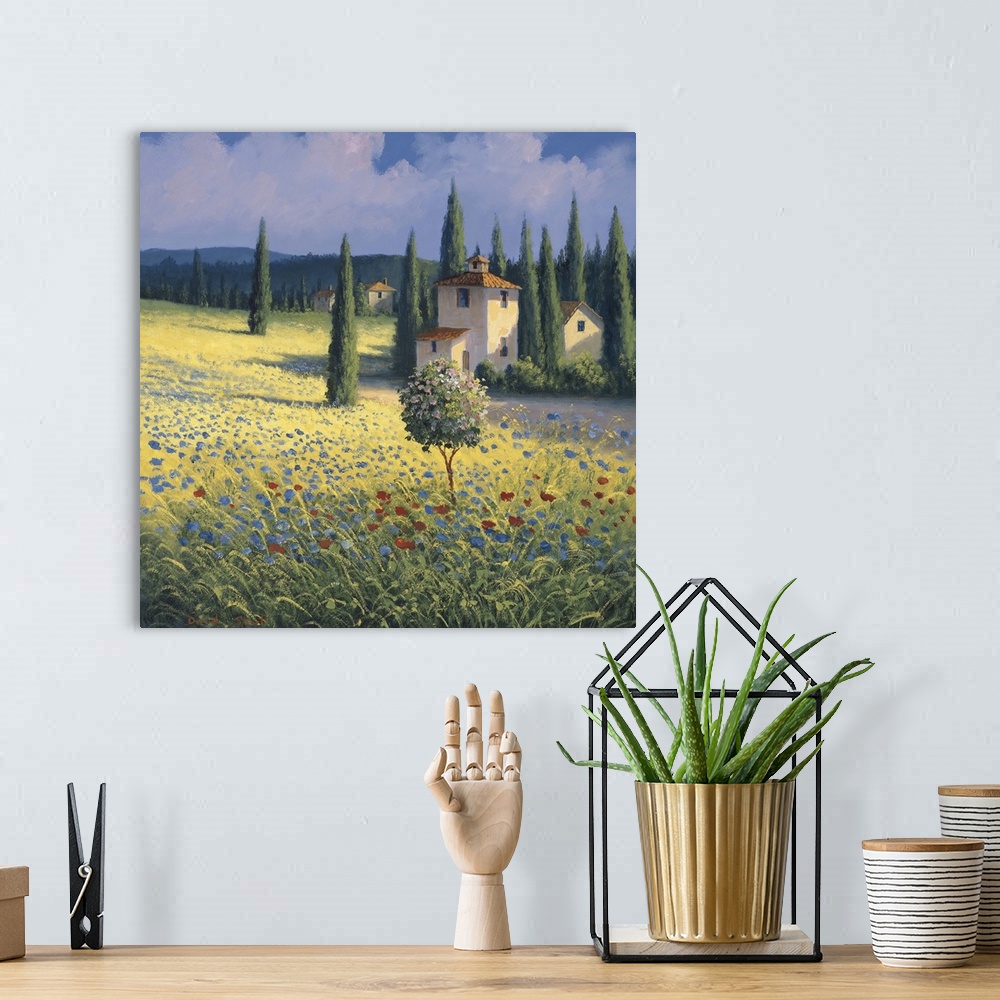 A bohemian room featuring Landscape painting of a Tuscan hillside with tall cypress trees.