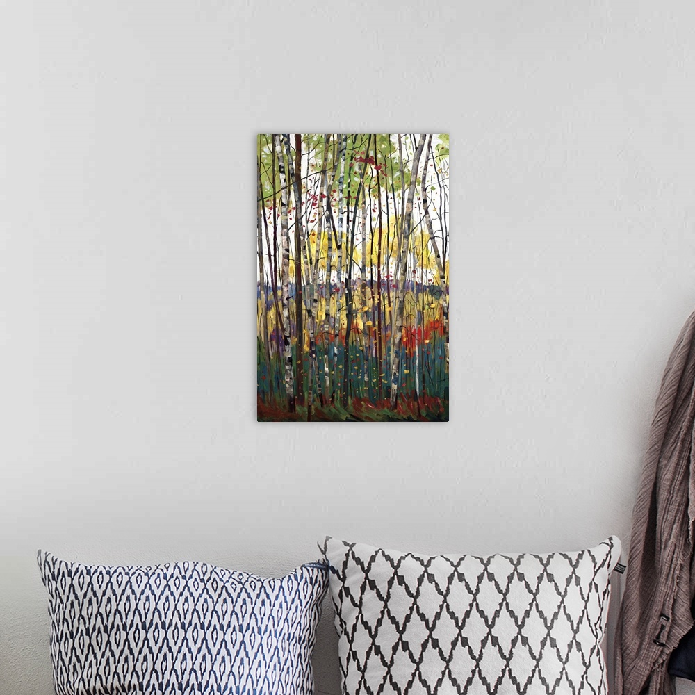 A bohemian room featuring Contemporary painting of a forest full of colorful trees in tones of red, yellow and orange.