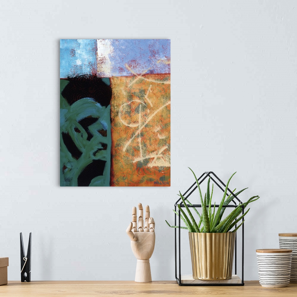 A bohemian room featuring Abstract landscape in four boxed shapes in different colors and layered elements.