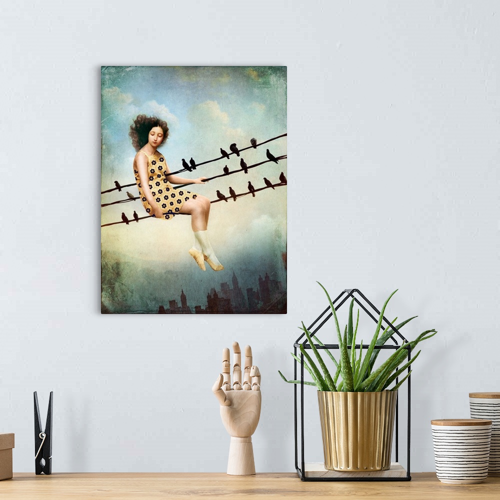 A bohemian room featuring A woman in a yellow dress in sitting on a power line with a row of birds over a city skyline.