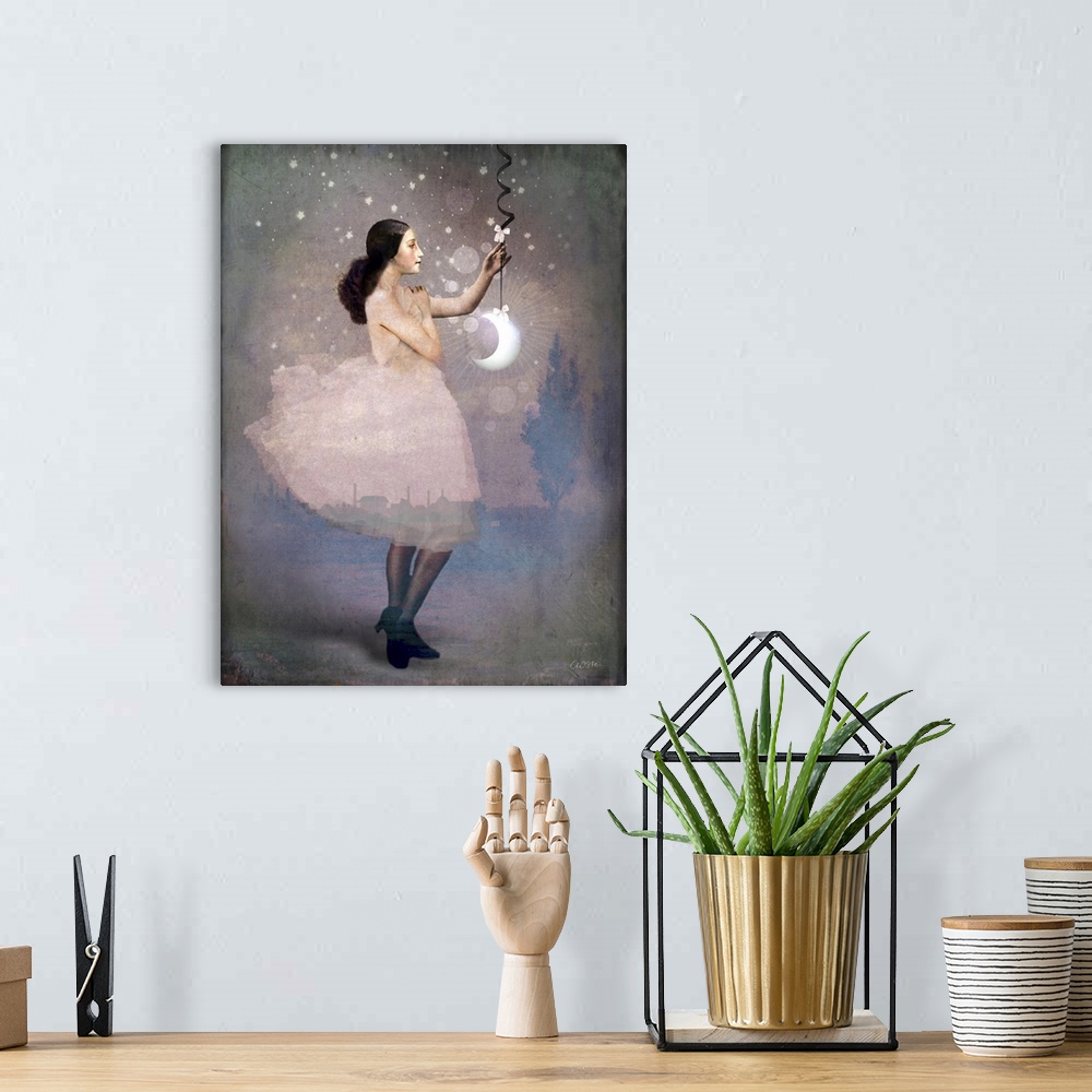 A bohemian room featuring A lady in pink is holding a crescent moon hanging from a ribbon.