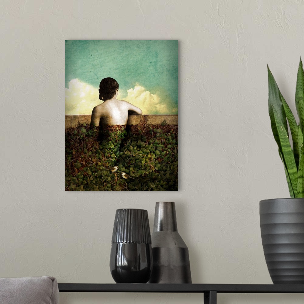 A modern room featuring A composite photograph of a female leaning on a wall covered with vines and two birds.