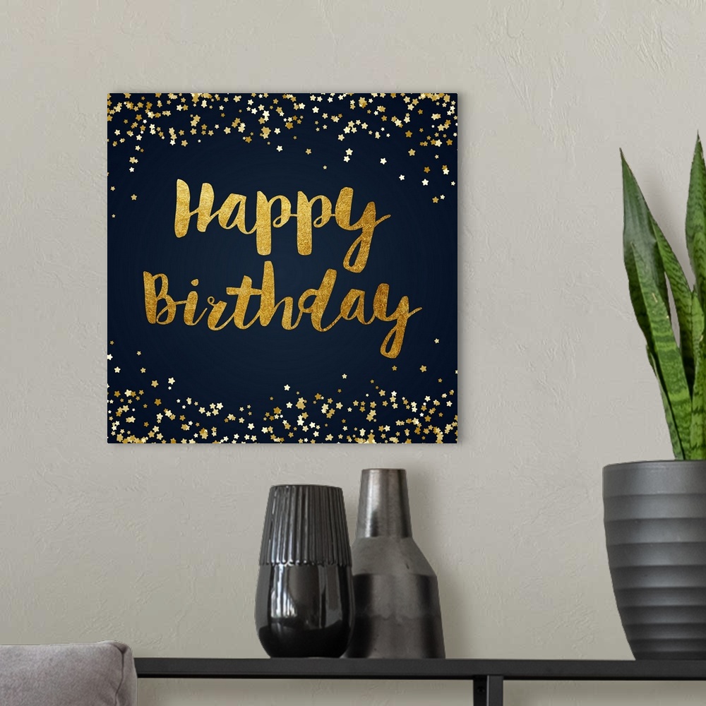 A modern room featuring "Happy Birthday" written in gold with sparkles on the top in bottom on a dark blue background.
