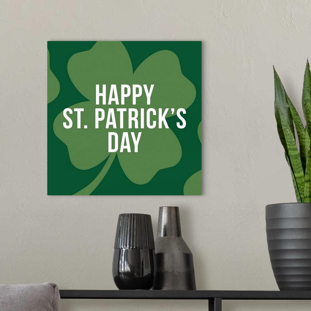 A modern room featuring "Happy St. Patrick's Day" written in white on top of a large four-leaf clover.