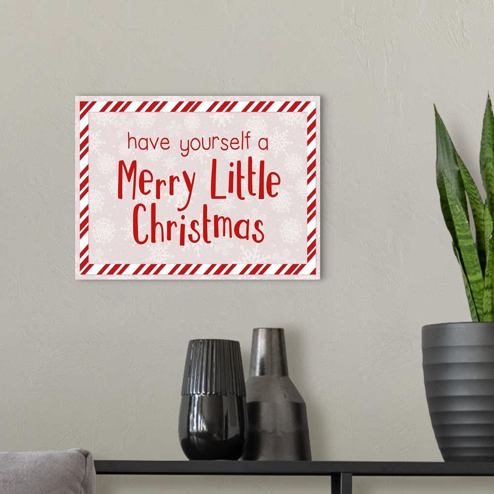 A modern room featuring Graphic holiday art with text surrounded by a striped rectangular border, on a light background w...