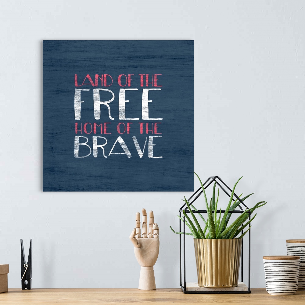 A bohemian room featuring "Land of the Free Home of the Brave" written in red and white on a blue background.