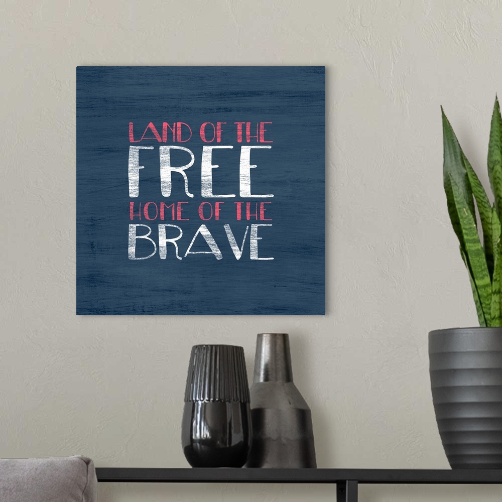 A modern room featuring "Land of the Free Home of the Brave" written in red and white on a blue background.