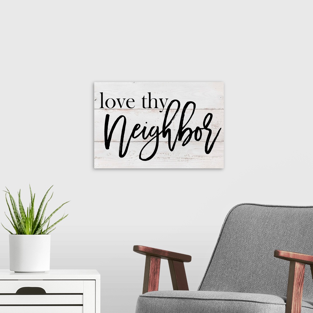 A modern room featuring "Love Thy Neighbor" on a white wood panel background.