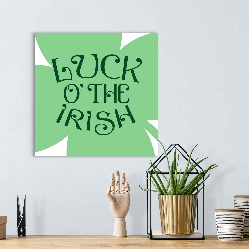 A bohemian room featuring "Luck of the Irish" written on top of a large four-leaf clover.