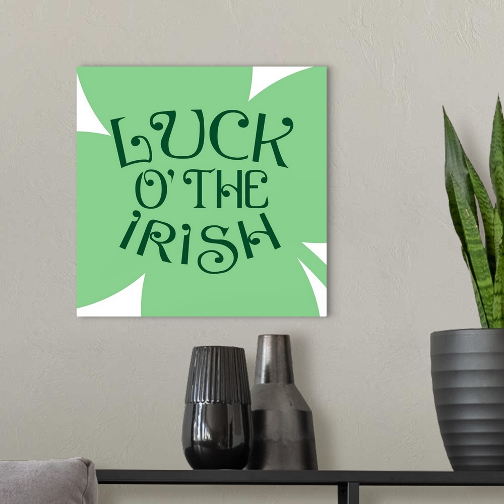 A modern room featuring "Luck of the Irish" written on top of a large four-leaf clover.
