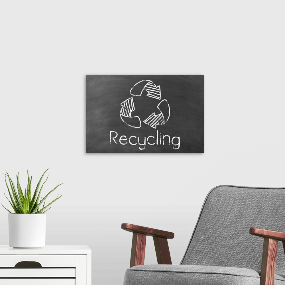 A modern room featuring Recycling symbol with "Recycling" written underneath in white on a black chalkboard background.