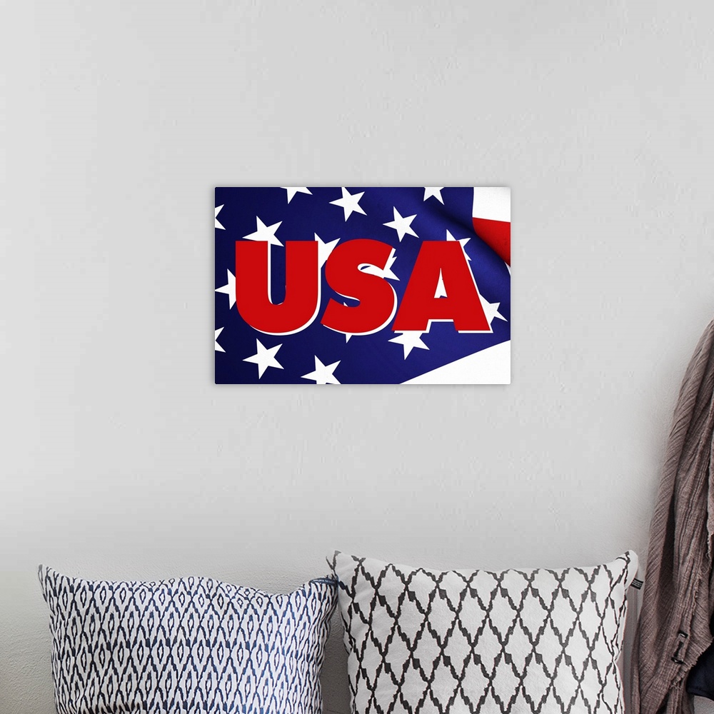 A bohemian room featuring USA in red on top of a waving American Flag.