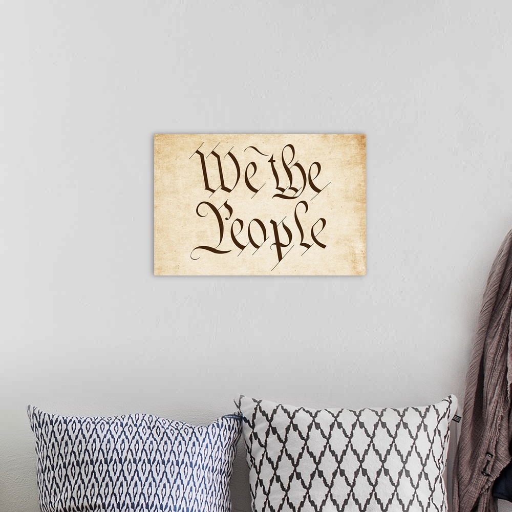 A bohemian room featuring "We the People" written in brown old timey script on a worn sepia background.