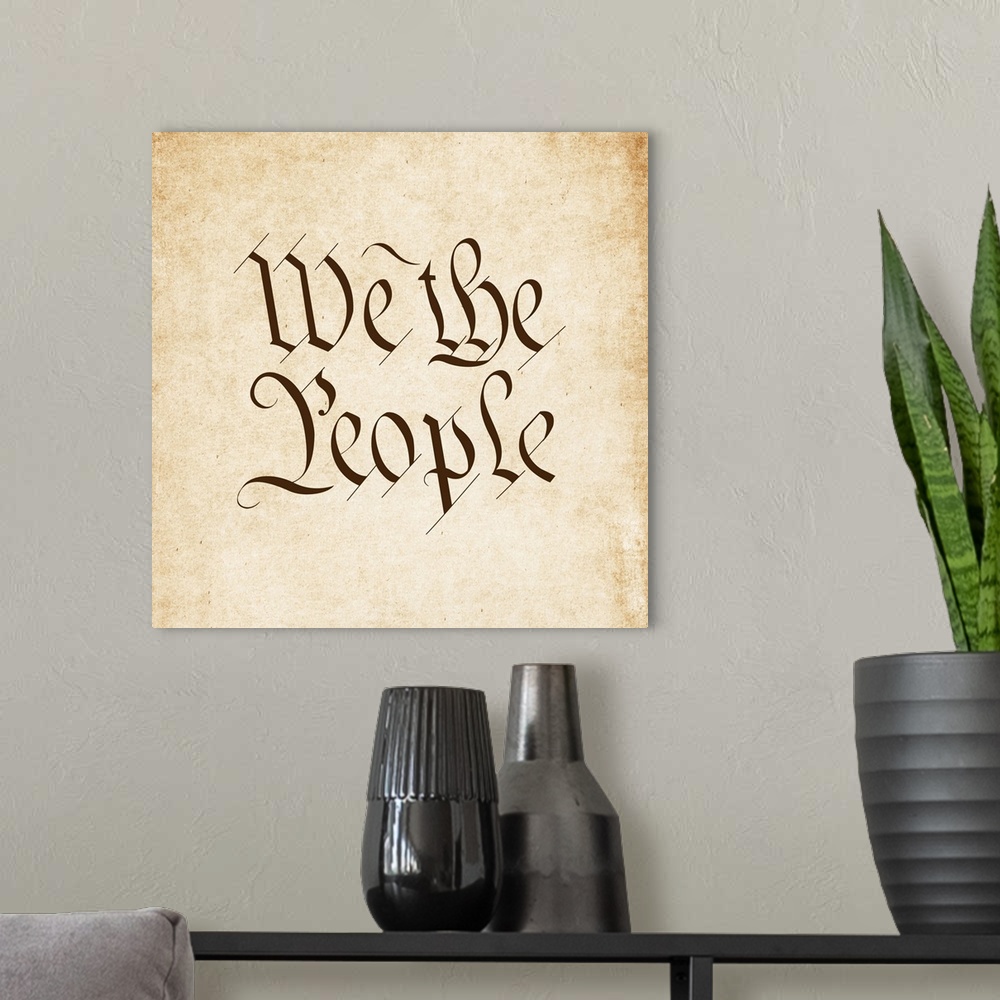 A modern room featuring "We the People" written in brown old timey script on a worn sepia background.