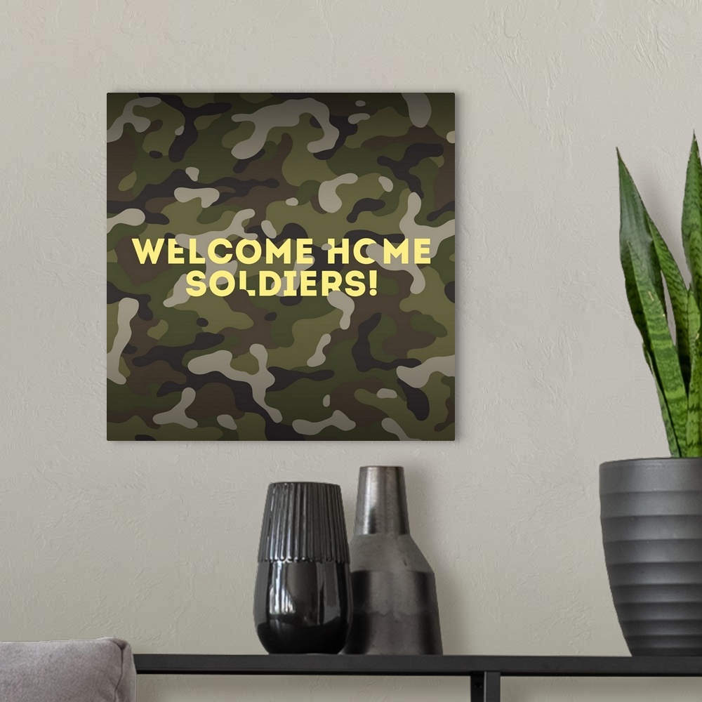 A modern room featuring "Welcome Home Soldiers!" written in yellow on a camouflaged background.
