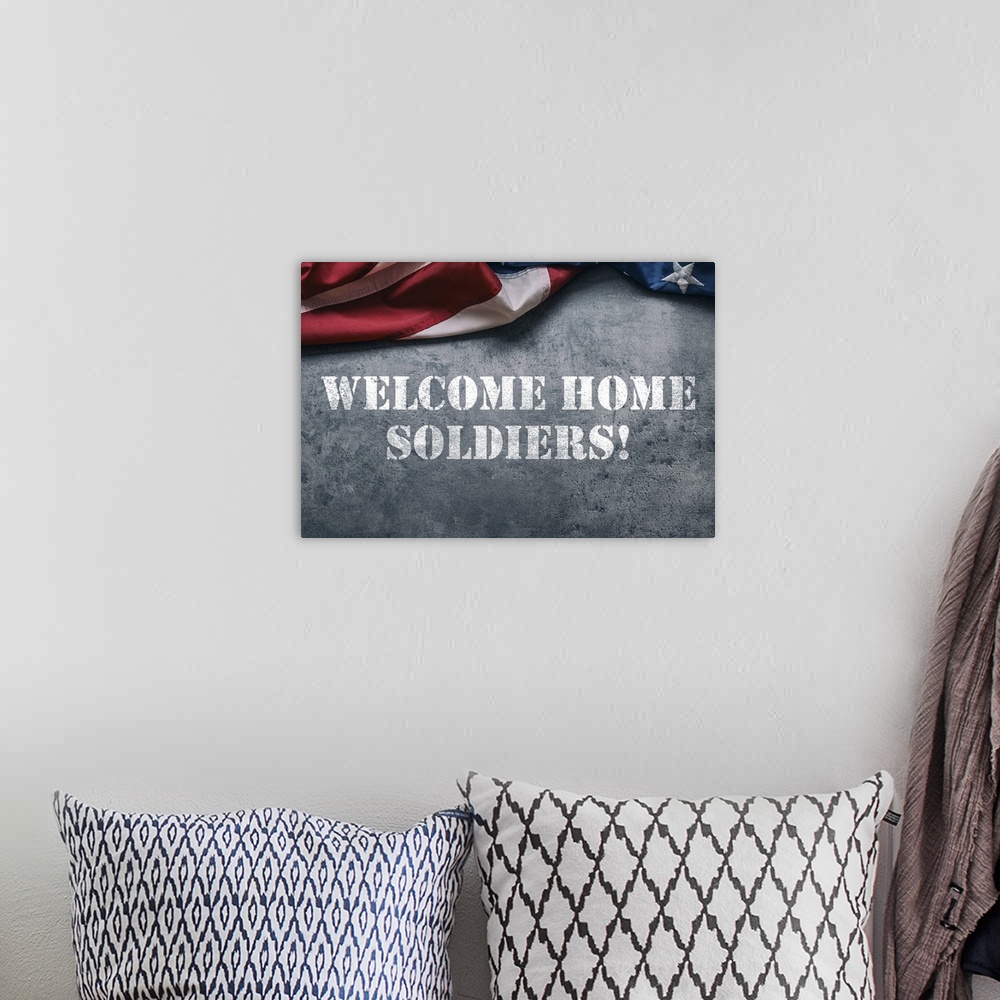 A bohemian room featuring "Welcome Home Soldiers!" stenciled in white with an American flag above it.