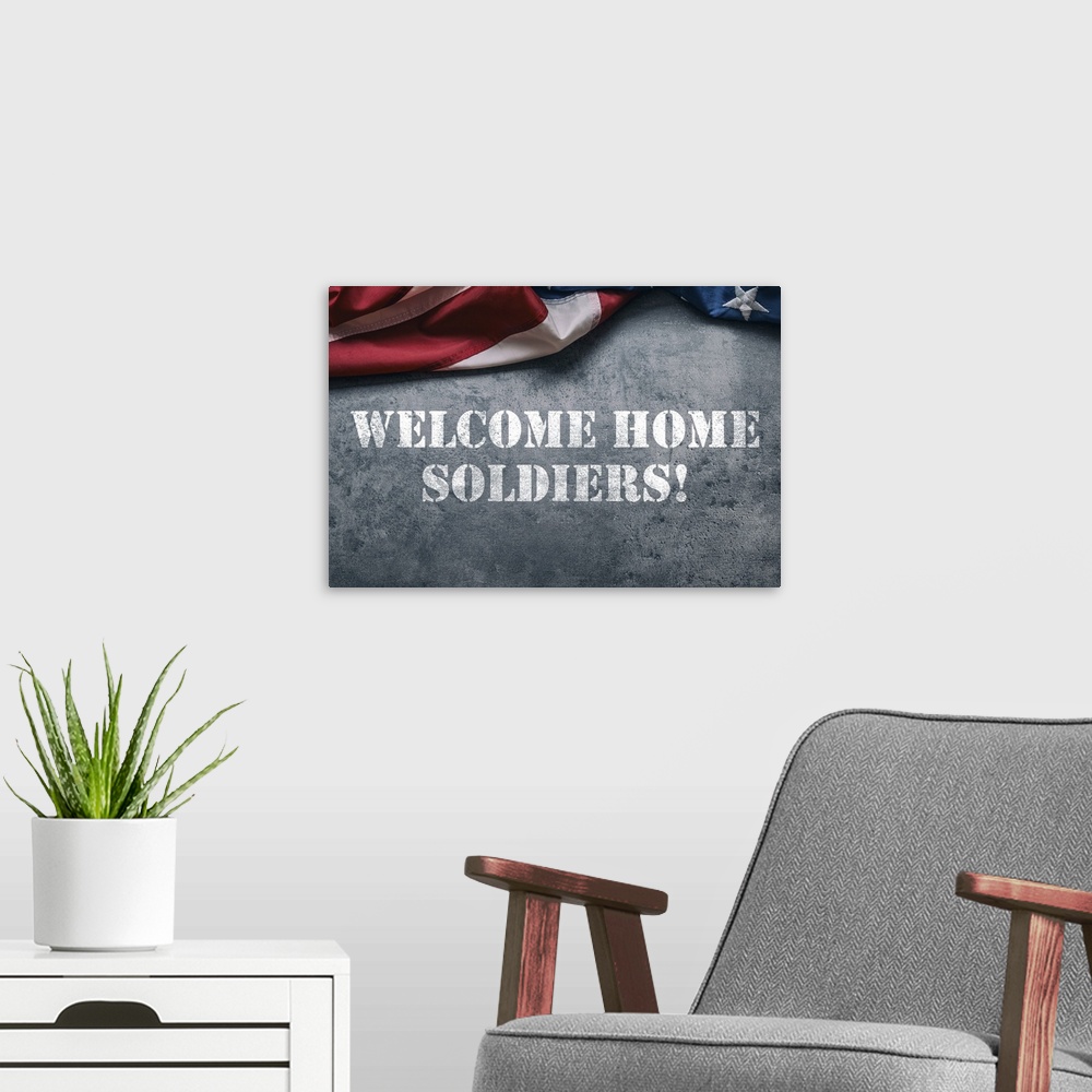 A modern room featuring "Welcome Home Soldiers!" stenciled in white with an American flag above it.