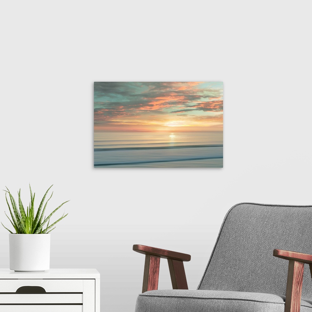 A modern room featuring A peaceful scene of the sun slowly rising over a calm stretch of ocean. The sky glows in shades o...